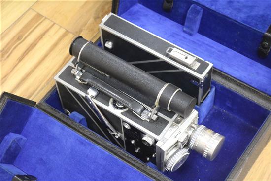 A Cine-Kodak Special II camera with accessories and travel case.